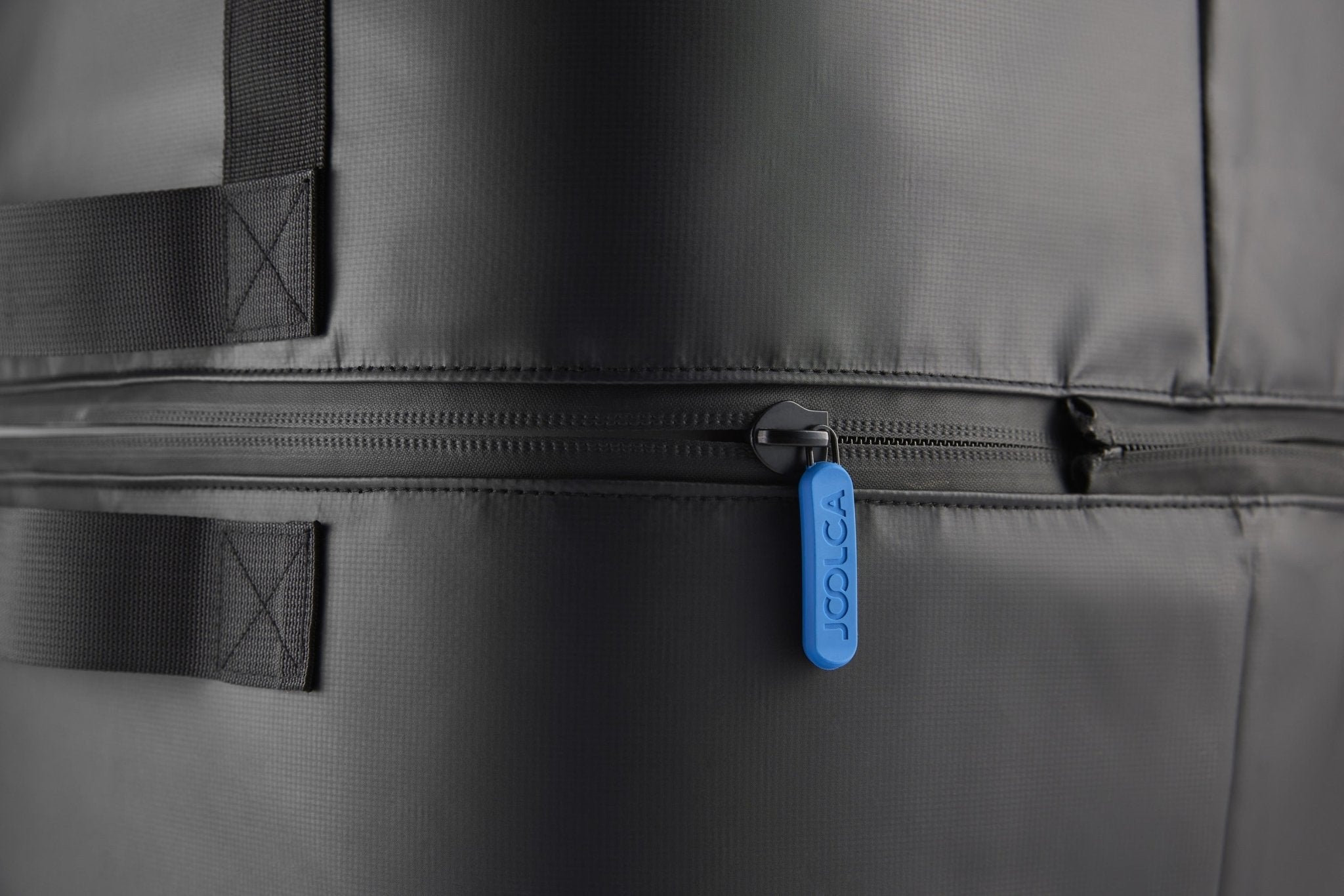 Close-up of the zip and side handle on the GottaGo carry bag