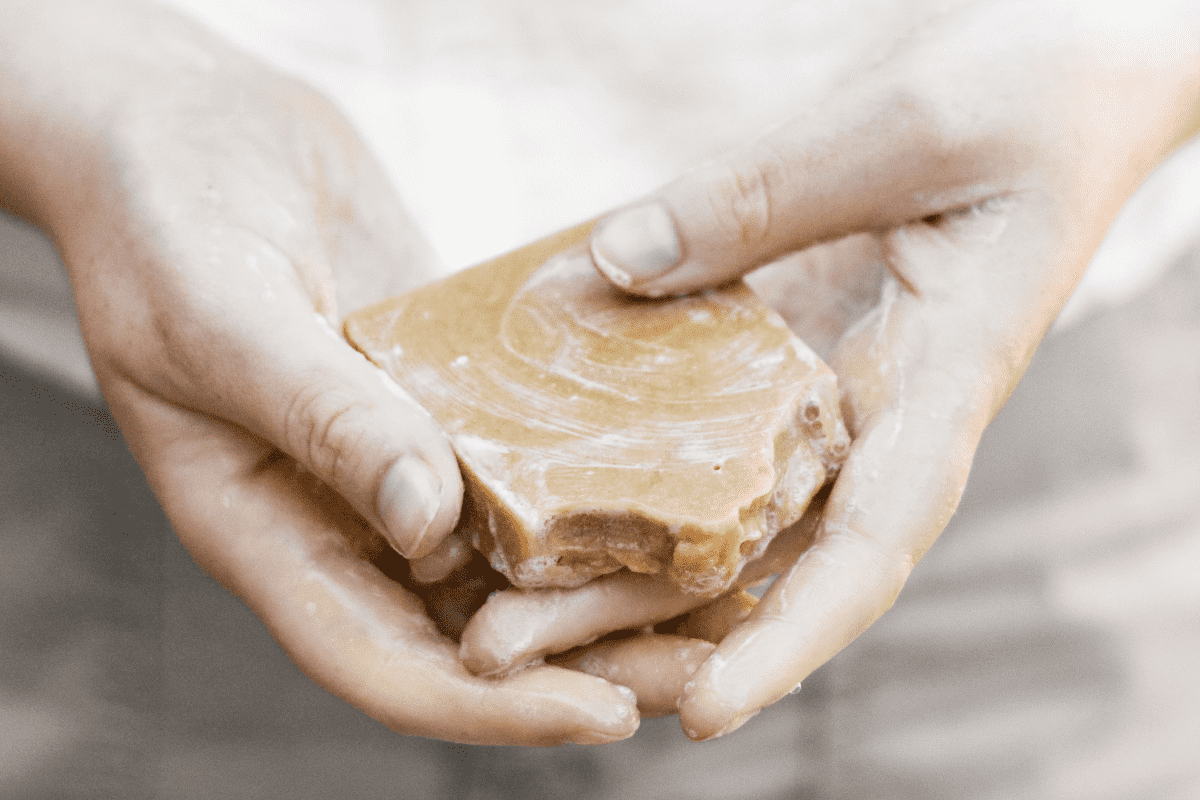 Hands holding a bar of natural soap