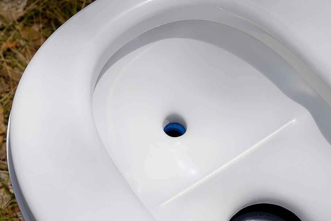 Close-up of the GottaGo bowl showing the small blue-rimmed urine opening