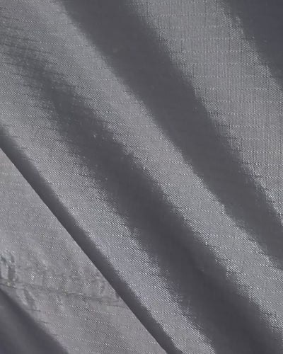 Close-up of a hand zipping up the Joolca Ensuite Mounted Single tent fabric
